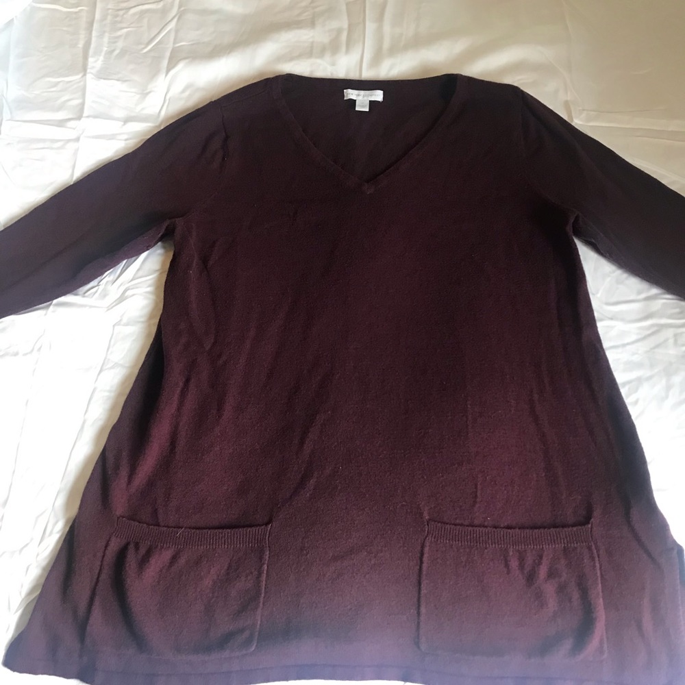 V-neck dark purple sweater.